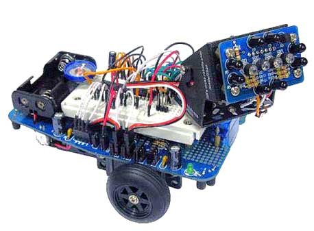 Mr. General is a general purpose robot platform designed to allow students to easily build their first robot. The bread board provides a solder free method of connecting almost any processor to Mr. General's sensors and servos. | Using 2 servos modified for continuous rotation, speed and direction of both wheels can be controlled using only 2 digital outputs. The 4 infrared sensors on the base can be used as analog or digital inputs for either edge detection or obstacle avoidance. | With the IR 